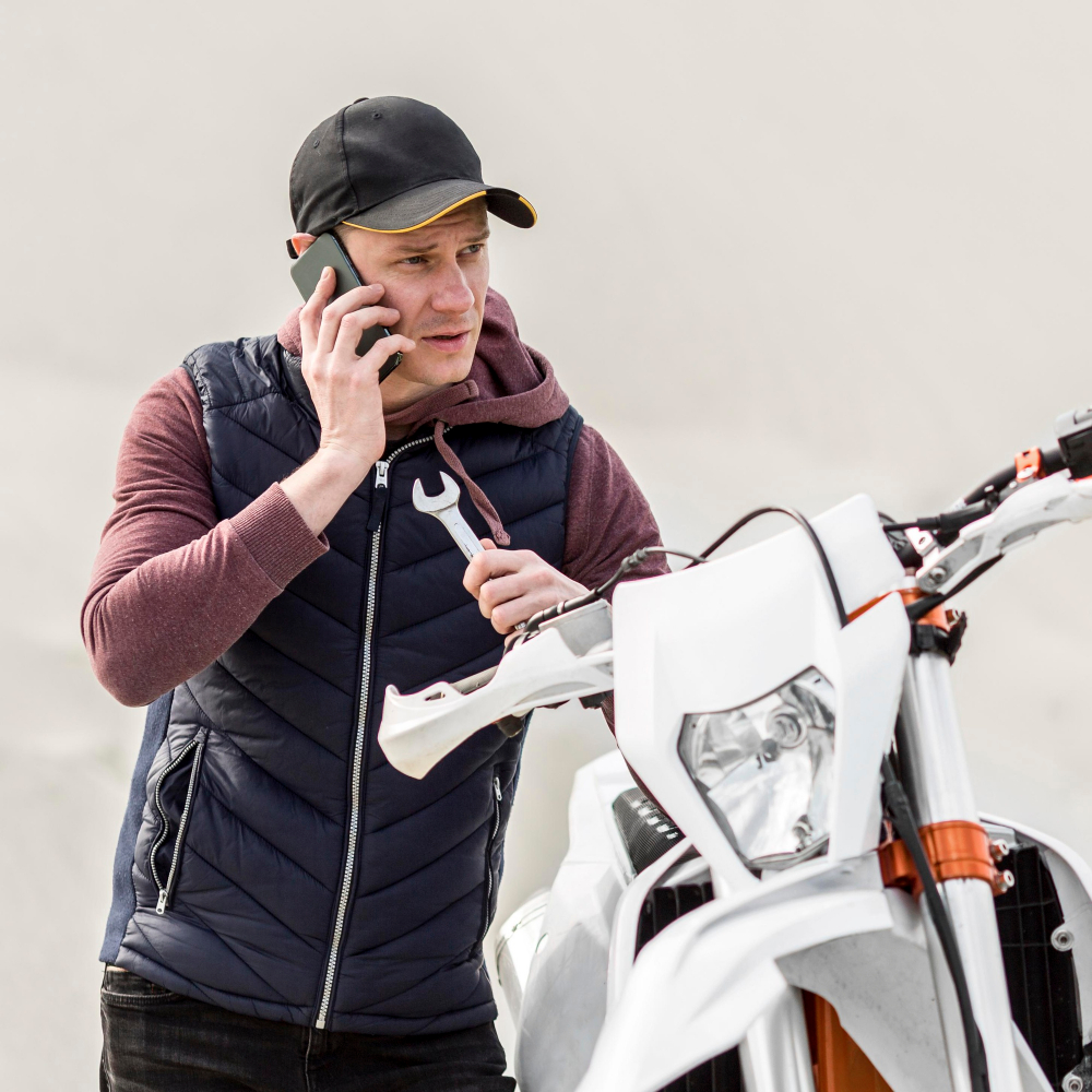 Man calling for help to repair his motorbike